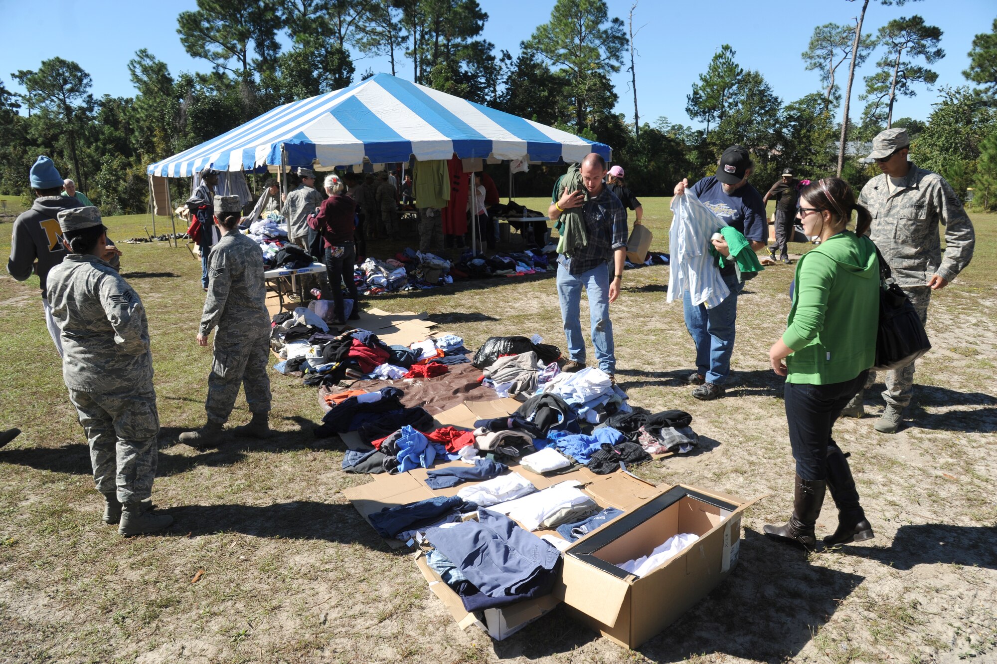Homeless veterans receive clothing from Keesler Air Force Base personnel and community volunteers during the 2014 Homeless Veteran Stand Down Oct. 16, 2014, at Hiller Park, Biloxi, Miss.  The Stand Down, sponsored by VA, local veteran organizations and other community organizations, provided medical services and information to homeless Veterans and families of homeless Veterans. The veterans received medical screenings, flu shots, VA social work services, a hot meal, haircuts, clothing, boots and blankets.  (U.S. Air Force photo Kemberly Groue)