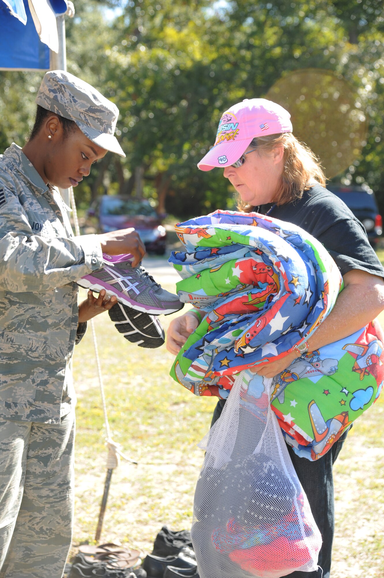 Staff Sgt. Sharde Jones, 334th Training Squadron, checks the shoe size for Army veteran Anita Parker, during the 2014 Homeless Veteran Stand Down Oct. 16, 2014, at Hiller Park, Biloxi, Miss The Stand Down, sponsored by VA, local veteran organizations and other community organizations, provided  medical services and information to homeless Veterans and families of homeless Veterans. The veterans received medical screenings, flu shots, VA social work services, a hot meal, haircuts, clothing, boots and blankets. Jones served from 1986-1989.  (U.S. Air Force photo Kemberly Groue)