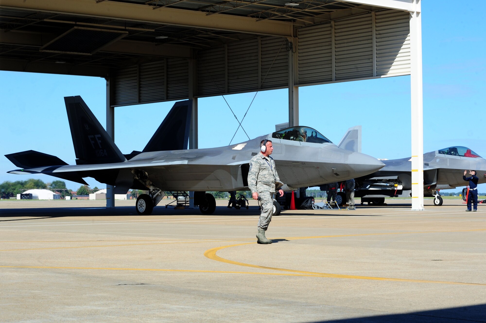 An F-22 Raptor from the 94th Fighter Squadron taxis onto the flight line during an exercise at Langley Air Force Base, Va., Oct. 16, 2014. The exercise was piloted by the 1st and 192nd Fighter Wings, and tested wing members’ ability to efficiently launch and retrieve aircraft. (U.S. Air Force photo by Air man 1st Class Areca T. Wilson/Released)