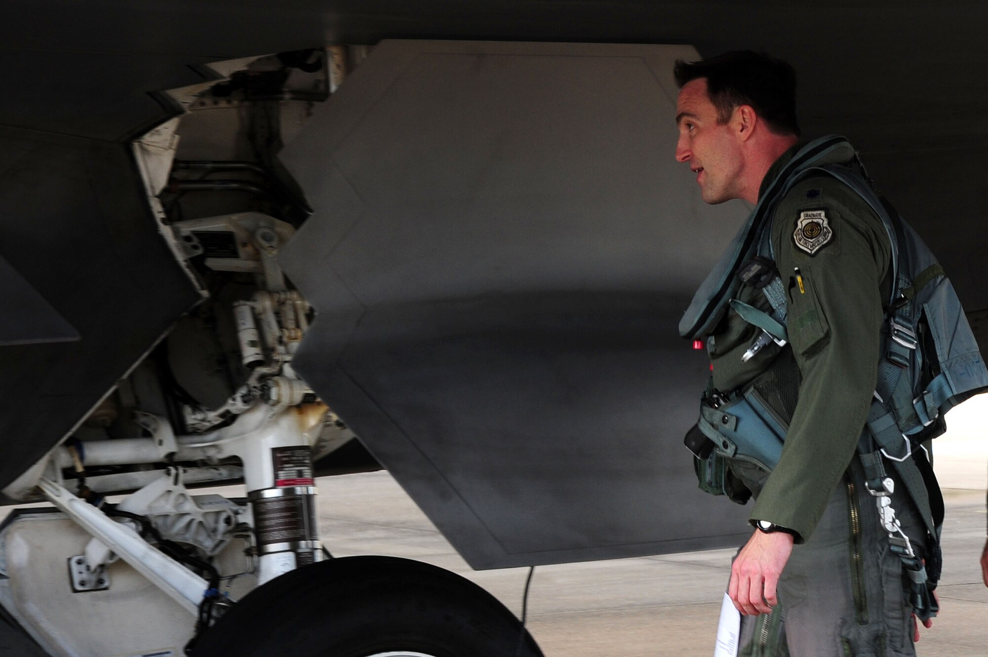U.S. Air Force Lt. Col. Jeff Hawkins, 94th Fighter Squadron commander, conducts a pre-flight check of an F-22 Raptor at Langley Air Force Base, Va., Oct. 16, 2014. Pre-flight checks are conducted to ensure the structural integrity of the aircraft prior to flight. (U.S. Air Force photo by Air man 1st Class Areca T. Wilson/Released)