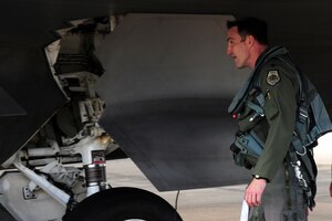 U.S. Air Force Lt. Col. Jeff Hawkins, 94th Fighter Squadron commander, conducts a pre-flight check of an F-22 Raptor at Langley Air Force Base, Va., Oct. 16, 2014. Pre-flight checks are conducted to ensure the structural integrity of the aircraft prior to flight. (U.S. Air Force photo by Air man 1st Class Areca T. Wilson/Released)