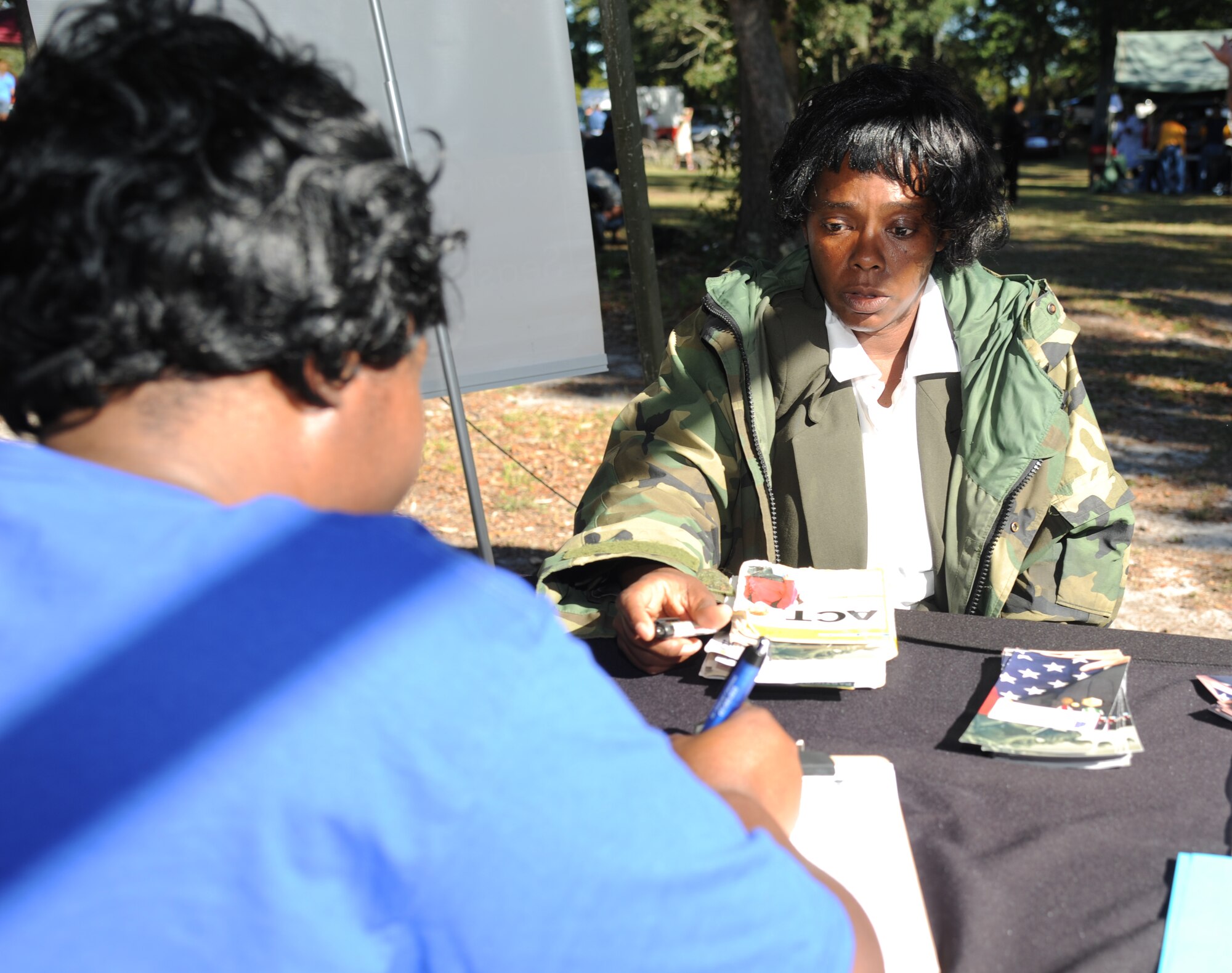 Tina Davis, Supportive Services for Veteran Families outreach coordinator, assists Denise Gaston, a homeless veteran, with housing opportunities during the 2014 Homeless Veteran Stand Down Oct. 16, 2014, at Hiller Park, Biloxi, Miss.  The Stand Down, sponsored by VA, local veteran organizations and other community organizations, provided medical services and information to homeless Veterans and families of homeless Veterans. The veterans received medical screenings, flu shots, VA social work services, a hot meal, haircuts, clothing, boots and blankets.  (U.S. Air Force photo Kemberly Groue)