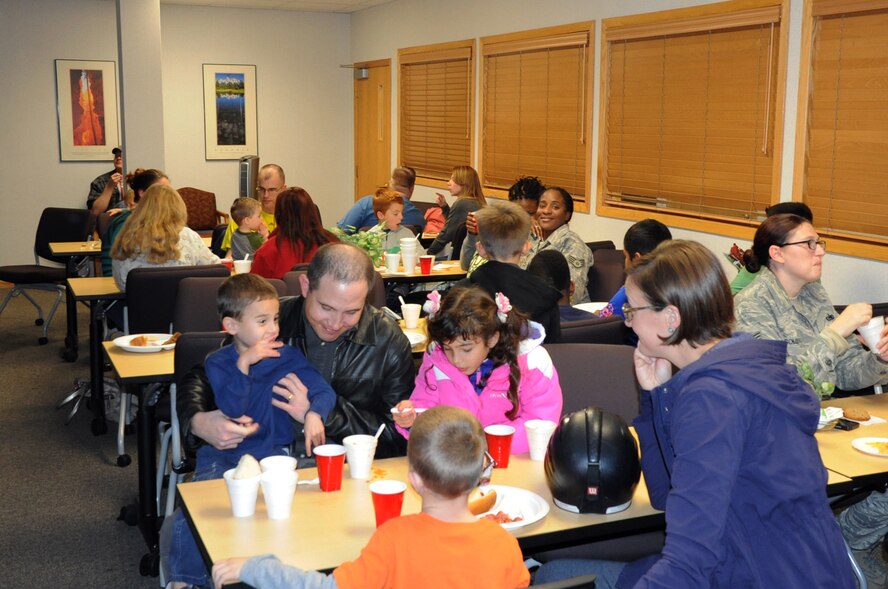 Airmen from the 319th Air Base Wing and their families enjoy a meal during the Airman & Family Readiness Center Soup Supper on Grand Forks Air Force Base, N.D., Oct. 16, 2014. The annual event attracted more than 300 guests to enjoy various homemade soups prepared by base residents. (U.S. Air Force photo/Staff Sgt. David Dobrydney)
