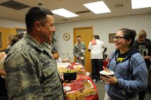 Col. Anthony Hernandez, 319th Mission Support Group commander, chats with Senior Airman Kimberly Palacios, 319th Comptroller Squadron customer service technician, at the Airman & Family Readiness Center Soup Supper on Grand Forks Air Force Base, N.D, Oct. 16, 2014. The annual event featured 28 different homemade soups from base residents. (U.S. Air Force photo/Staff Sgt. David Dobrydney)