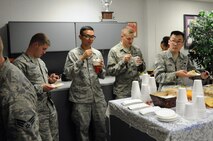 Airmen from the 319th Air Base Wing enjoy soup and dessert at the 8th Annual Soup Supper at the Airman & Family Readiness Center on Grand Forks Air Force Base, N.D., Oct. 16, 2014. More than 300 Airmen, civilian employees, spouses and children came to the event to sample 28 different homemade soups. (U.S. Air Force photo/Staff Sgt. David Dobrydney)