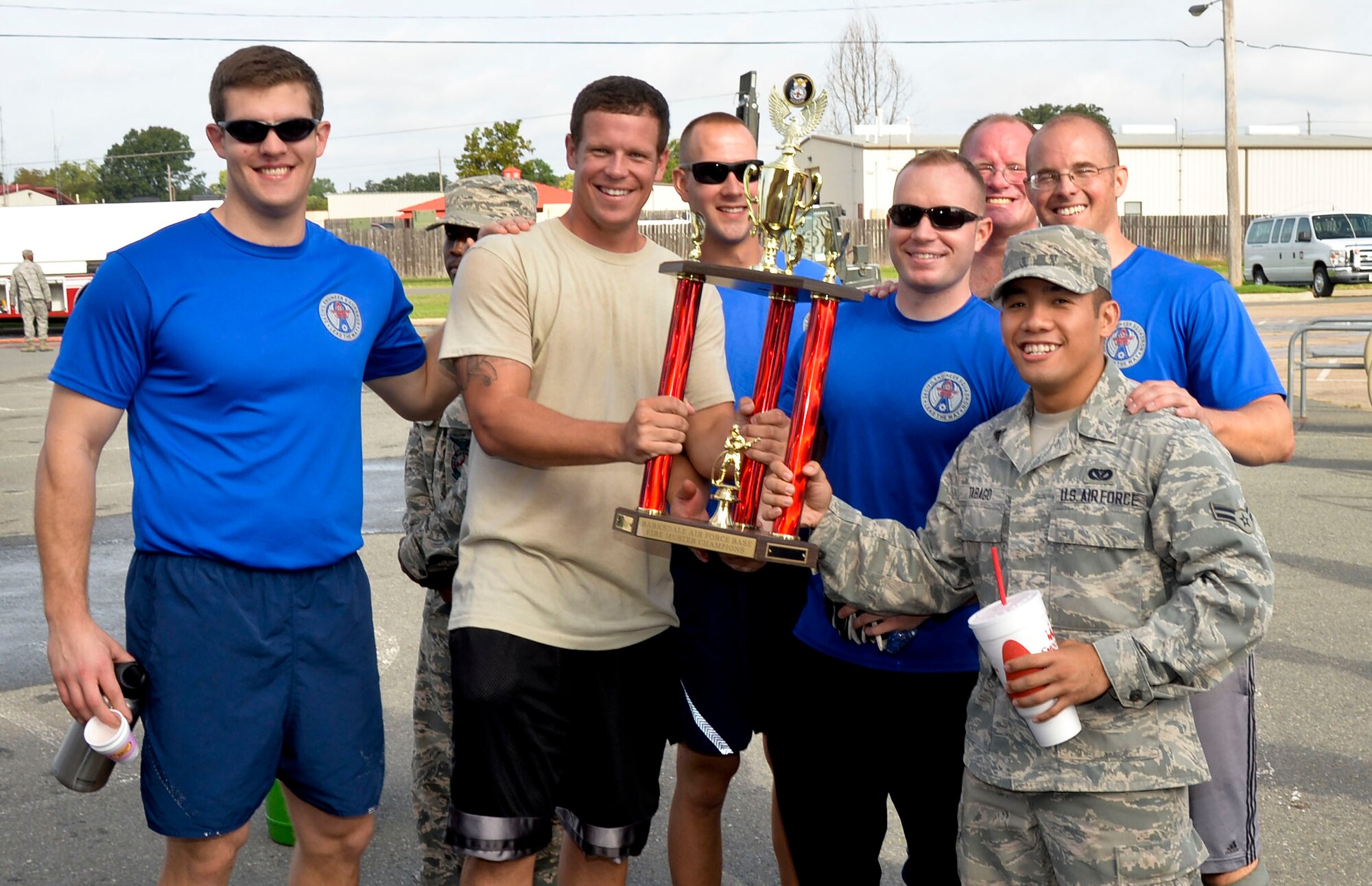 Airmen from the 2nd Civil Engineer Squadron receive the 1st place trophy during the 2014 fire muster on Barksdale Air Force Base, La., Oct. 9, 2014.  Airmen from the 2nd CES won the challenge with a time of 1 minute, 39 seconds, beating seven participating teams. (U.S. Air Force photo/Airman 1st Class Mozer O. Da Cunha)
