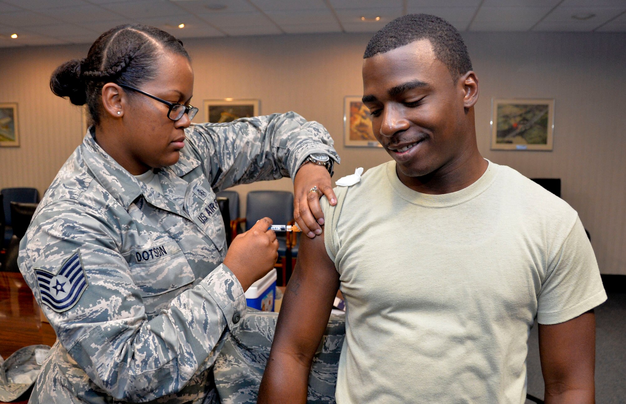 Staff Sgt. Isaac Garden, 2nd Bomb Wing Public Affairs broadcast journalist, receives a flu shot on Barksdale Air Force Base, La., Oct. 9, 2014. The flu shot is mandatory for all military members. In addition to receiving the annual vaccination, personnel should wash their hands frequently to reduce the spread of germs. (U.S. Air Force photo/Airman 1st Class Mozer O. Da Cunha)