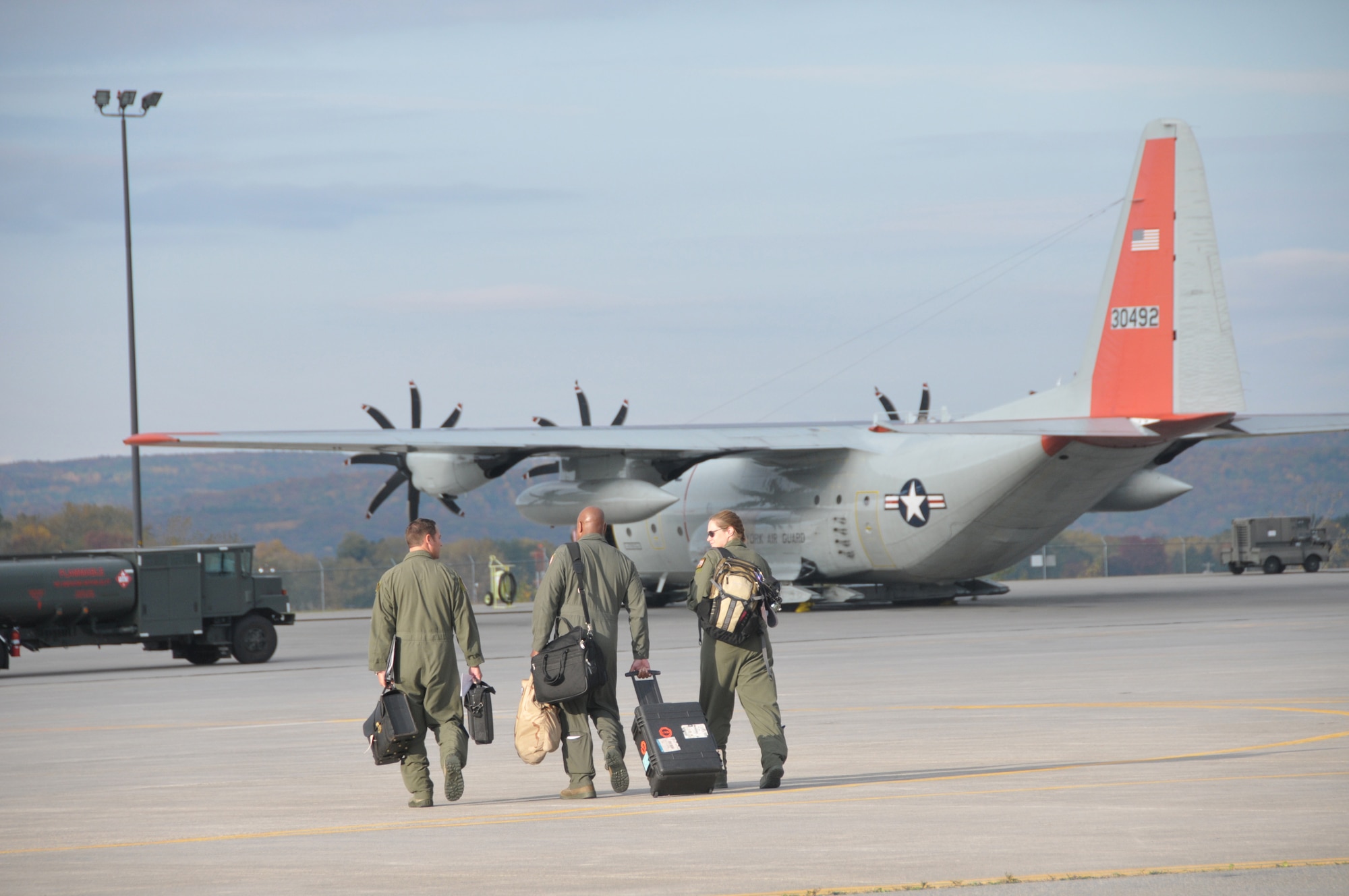 The aircrew heads out to an LC-130 Hercules that will begin its journey to the South Pole. The LC-130 and crew with the 109th Airlift Wing took off from Stratton Air National Guard Base, Scotia, New York, on Oct. 17, 2014. The aircraft is headed to Antarctica for the Wing's 27th year participating in Operation Deep Freeze in support of the National Science Foundation. The 109th AW boasts the U.S. military's only ski-equipped aircraft, which has been supporting the NSF's South Pole research since 1988. (U.S. Air National Guard photo by Master Sgt. William Gizara/Released)