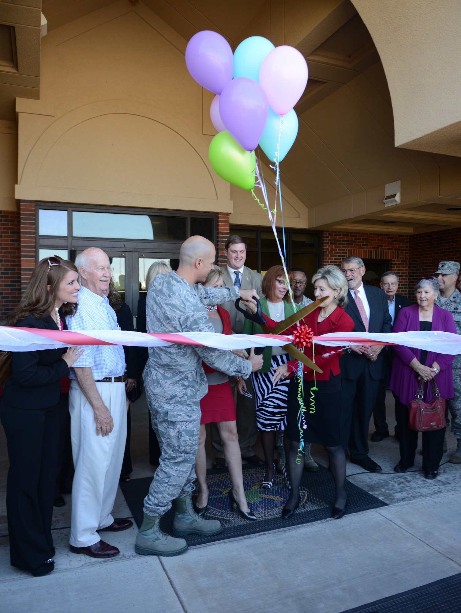 Base leadership, community leaders and other distinguished guests to include former U.S. Senator Kay Bailey Hutchison, cut a ribbon in front of the newly named Kay Bailey Hutchison Child Development Center (CDC) Oct. 15, 2014, at Dyess Air Force Base, Texas. The CDC on Dyess has been the number one child care facility in Air Combat Command for each of the last two years. The $5.4 million, 26,000-square foot facility was built in 2002, holds 18 classrooms, and has the capacity to care for 247 children. (U.S. Air Force photo by Airman 1st Class Kedesha Pennant/Released)