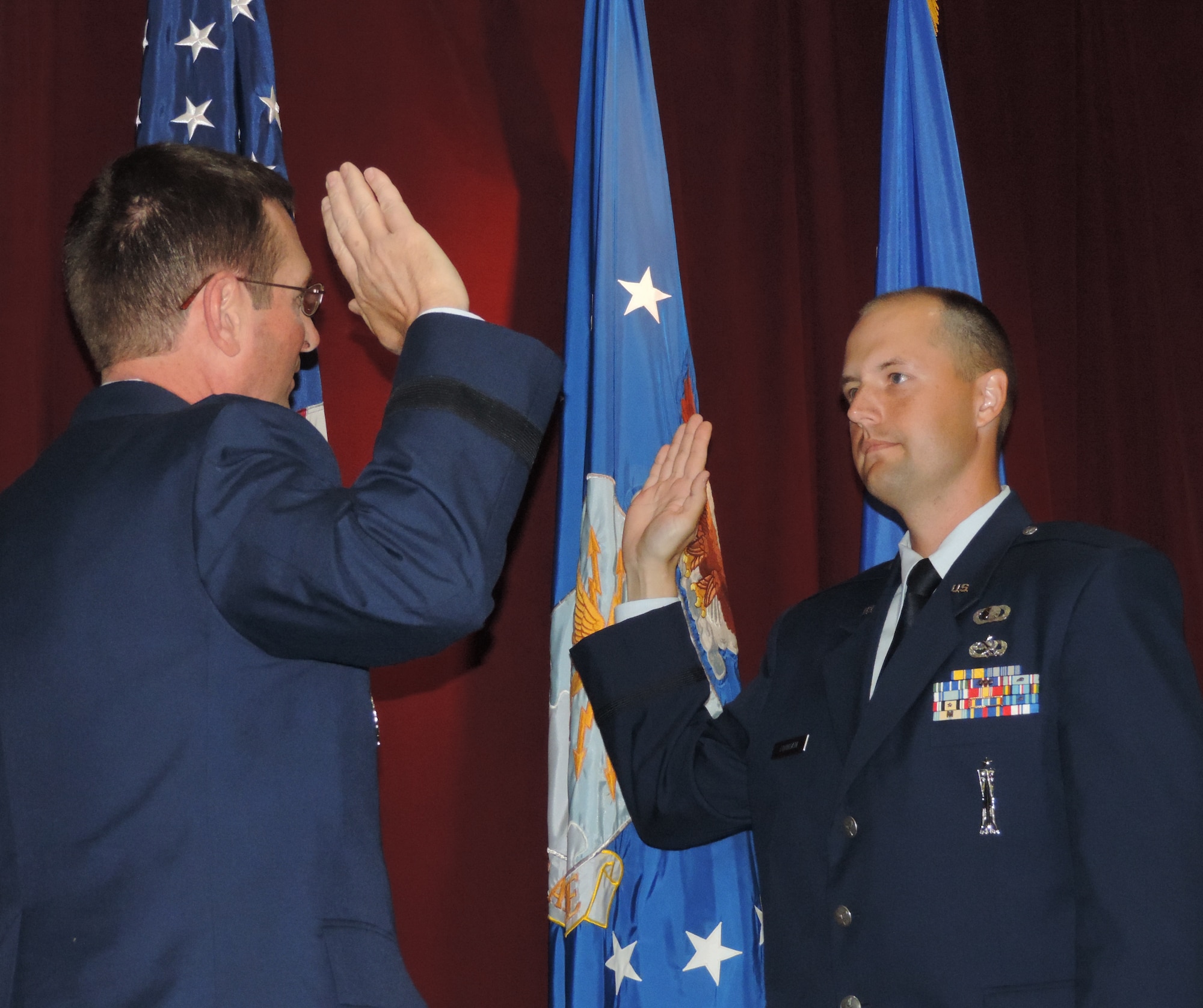 At a commissioning ceremony for the Academy of Military Science at Maxwell Air Force Base, Ala., Lt. Gen. Joseph L. Lengyel administers the state oath of office to Officer Candidate Phillip B. Fountain. With this ceremony, Fountain became a second lieutenant in the Texas Air National Guard and the United States Air Force. This is unique for National Guard members where they swear to obey the orders of the President of the United States and their respective Governor. (Air National Guard photo by Col. Nahaku A. McFadden)