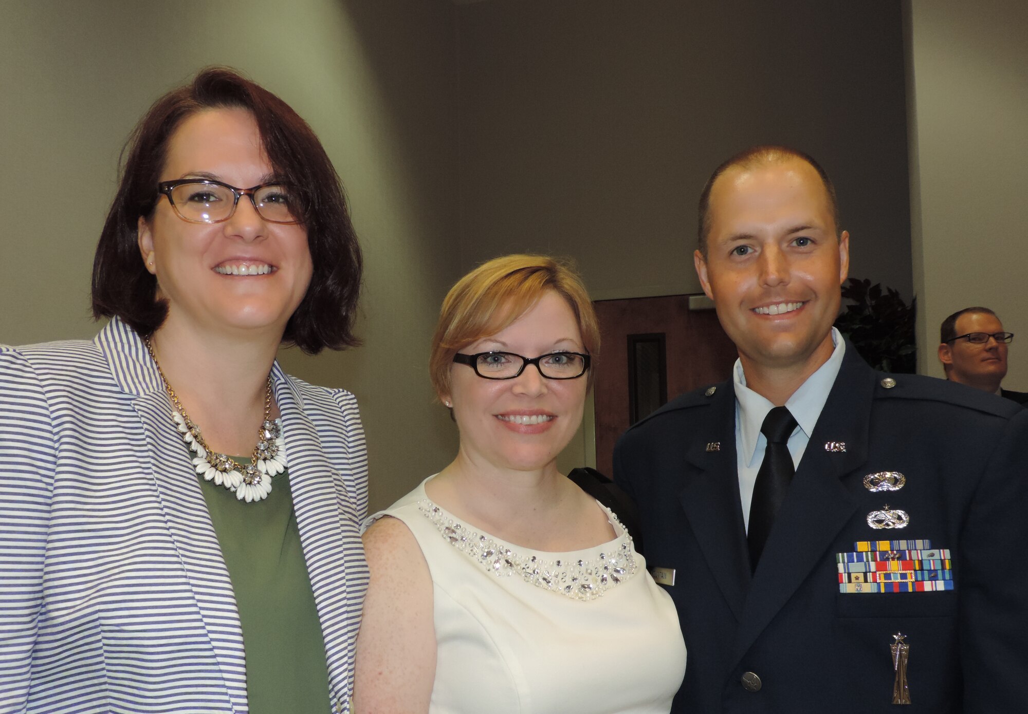 Moments before he is commissioned from the Air National Guard’s Academy of Military Science at Maxwell Air Force Base, Ala.,    Officer Candidate Phillip B. Fountain poses and his friend Lesey Smith and wife Amber. (Air National Guard photo by Col. Nahaku A. McFadden)