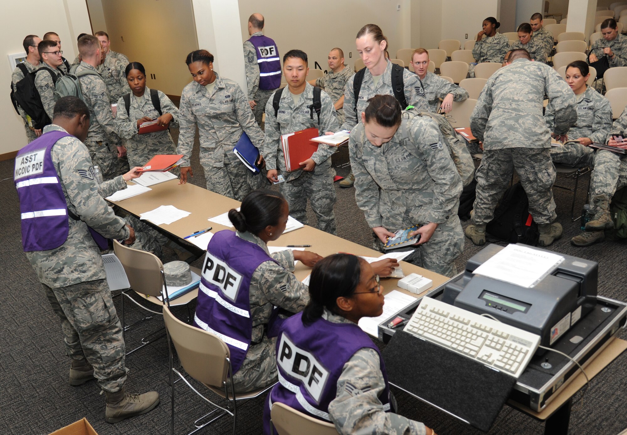 Airmen process through the deployment line during a humanitarian deployment exercise Oct. 16, 2014, at the Roberts Consolidated Aircraft Maintenance Facility, Keesler Air Force Base, Miss. The exercise scenario tested the mission readiness of Team Keesler members for world-wide deployments. (U.S. Air Force photo by Kemberly Groue)