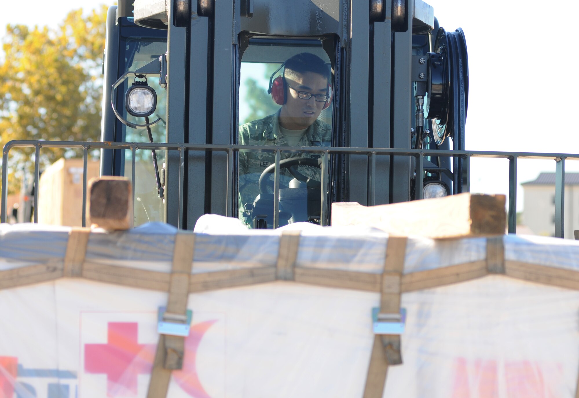 Airman 1st Class Gun Lee, 81st Logistics Readiness Squadron, operates a forklift for transporting cargo at the supply warehouse loading docks during a humanitarian deployment exercise Oct. 15, 2014, at the Taylor Logistics Center, Keesler Air Force Base, Miss.  The exercise scenario tested the mission readiness of Team Keesler members for world-wide deployments. (U.S. Air Force photo by Kemberly Groue)