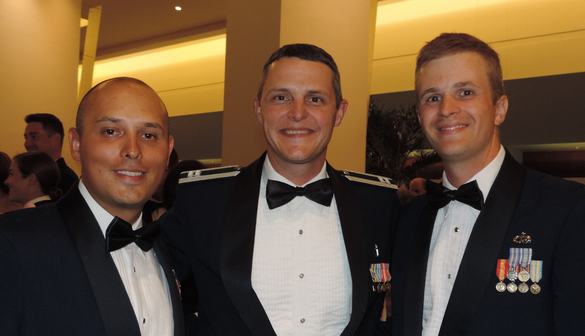 Officer Candidates Scott Himes, 118th Airlift Wing, Tenn. and Nick Robles, 179th Airlift Wing, Ohio, pose with Academy of Military Science chaplain, Capt. Clay Carroll, 187th Fighter Wing, Ala. They were attending the Air National Guard’s Academy of Military Science’s Dining Out at Maxwell Air Force Base, Ala. (Air National Guard photo by Col. Nahaku A. McFadden)