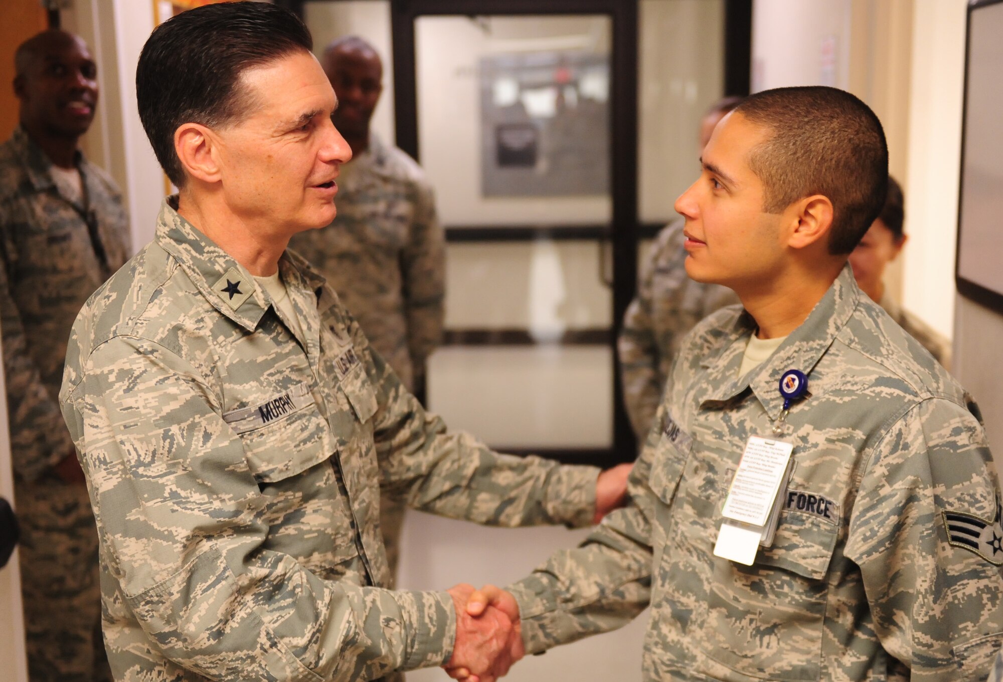 Senior Airman David Callejas, 4th Aerospace Medicine Squadron public health technician, greets Brig Gen. (Dr.) Sean Murphy, the command surgeon at Air Combat Command, during an orientation tour of the 4th Medical Group on Oct. 17, 2014, at Seymour Johnson North Carolina. Murphy took the time to interact with the Airmen assigned to the 4th MDG and received several briefings on future upgrades to the facility. (U.S. Air Force photo/Airman 1st Class Brittain Crolley)