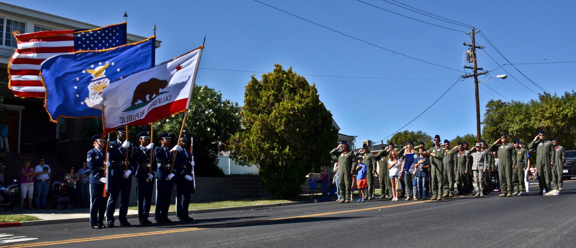 The Travis Air Force Base Honor Guard presents the colors during the singing of the national anthem Oct. 12, 2014, at the Rio Vista Bass Derby Parade. More than 30 Travis Airmen and their families participated in the parade to support the Rio Vista event. (U.S. Air Force photo by Airman 1st Class Amber Carter)