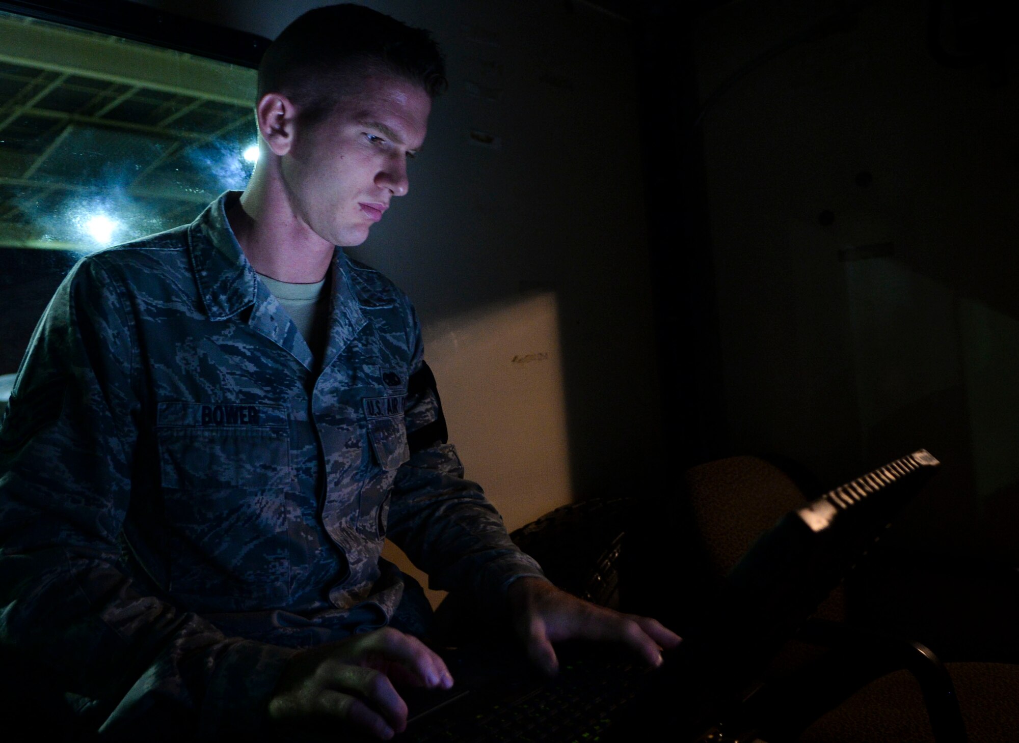 U.S. Air Force Staff Sgt. Corey Bower, 94th Air Maintenance Unit Team 25 weapons load team leader, checks the workload for his team’s shift at Langley Air Force Base, Va., Oct. 14, 2014. Three-Airman teams load the jets the night before they fly, which means checking weapons bays, loading munitions and conducting post-load inspections. (U.S. Air Force photo by Senior Airman Austin Harvill/Released)