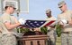 Senior Airmen Caleb Lay and Taylor Hill and Airman 1st Class Nicholas Poultney practice the precision movements of a flag-folding ceremony. (Air Force photo by Kelly White)