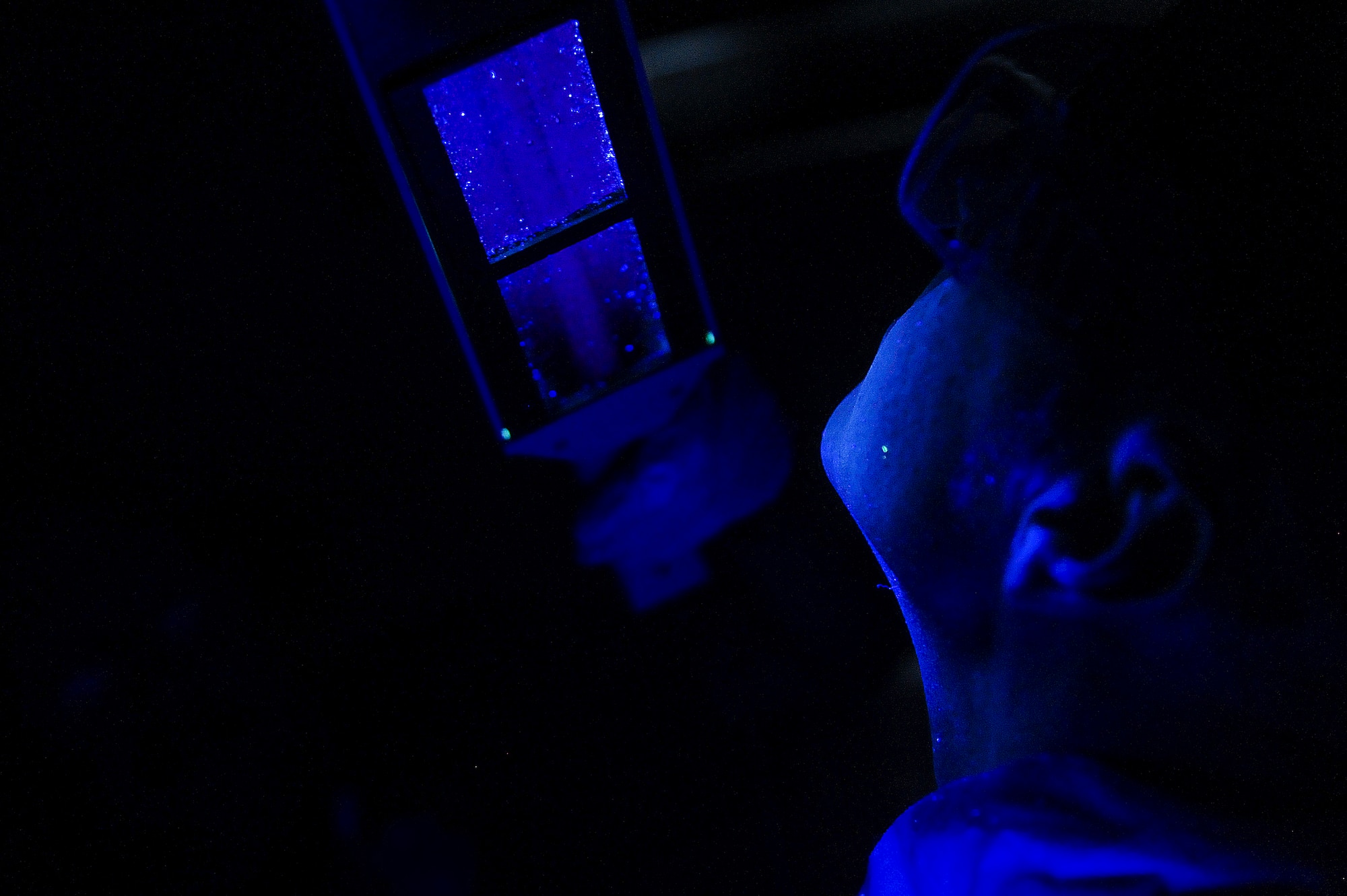 Tech. Sgt. Phillip Ryan, NCO in charge of Aircrew Flight Equipment assigned to the 388th Operations Support Squadron at Hill Air Force Base, Utah, receives an ultraviolet inspection as part of the decontamination process during an Air Combat Command Joint Aircrew Flight Equipment evaluation testing Oct. 14, 2014, at Seymour Johnson Air Force Base, North Carolina. Representatives from several bases including Joint Base Langley-Eustis, Ellsworth, Seymour Johnson, Beale, Tinker, Davis-Monthan, Nellis and Hill Air Force Base, were on hand to test current and future flight equipment for every aircraft in the Air Force inventory, including the newest fighter, the military's F-35 Joint Strike Fighter. (U.S. Air Force photo/Airman 1st Class Brittain Crolley)