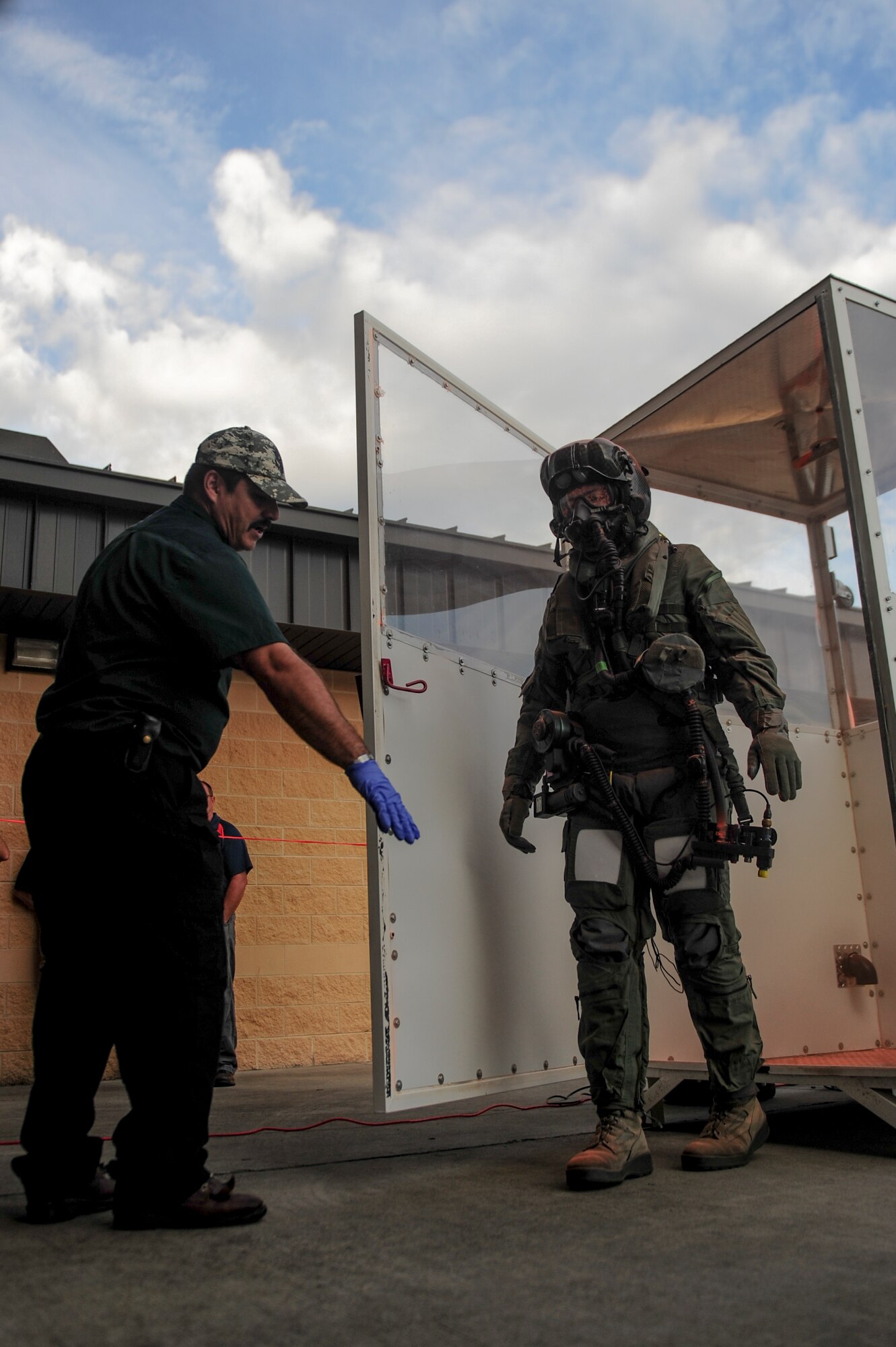 Airman 1st Class Kyle Rogers (right), an Aircrew Flight Equipment specialist assigned to the 355th Operations Support Squadron at Davis-Monthan Air Force Base, Arizona, receives directions from Miguel Vigil after exiting a gas chamber during an Air Combat Command Joint Aircrew Flight Equipment evaluation testing Oct. 14, 2014, at Seymour Johnson Air Force Base, North Carolina. Representatives from several bases including Joint Base Langley-Eustis, Ellsworth, Seymour Johnson, Beale, Tinker, Davis-Monthan, Nellis and Hill Air Force Base, were on hand to test current and future flight equipment for every aircraft in the Air Force inventory, including the newest fighter, the military's F-35 Joint Strike Fighter. (U.S. Air Force photo/Airman 1st Class Brittain Crolley)