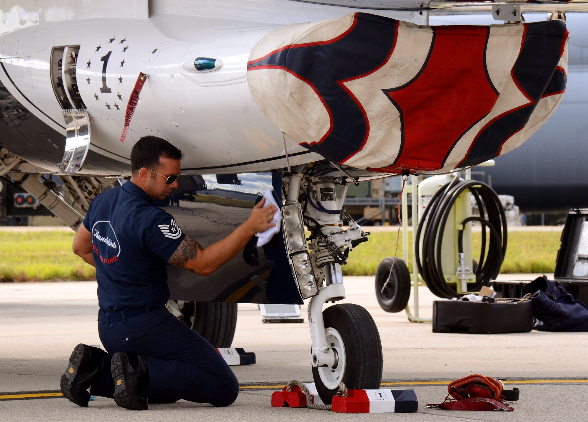 Tech. Sgt. Nathaniel Santiago polishes his Thunderbird aircraft soon after landing at Dobbins Air Reserve Base, Ga., Oct., 16. The U.S. Air Force Air Demonstration Squadron Thunderbirds will be performing this weekend at the Russell Regional Airport in Rome, Ga. (U.S. Air Force photo/Brad Fallin/Released)