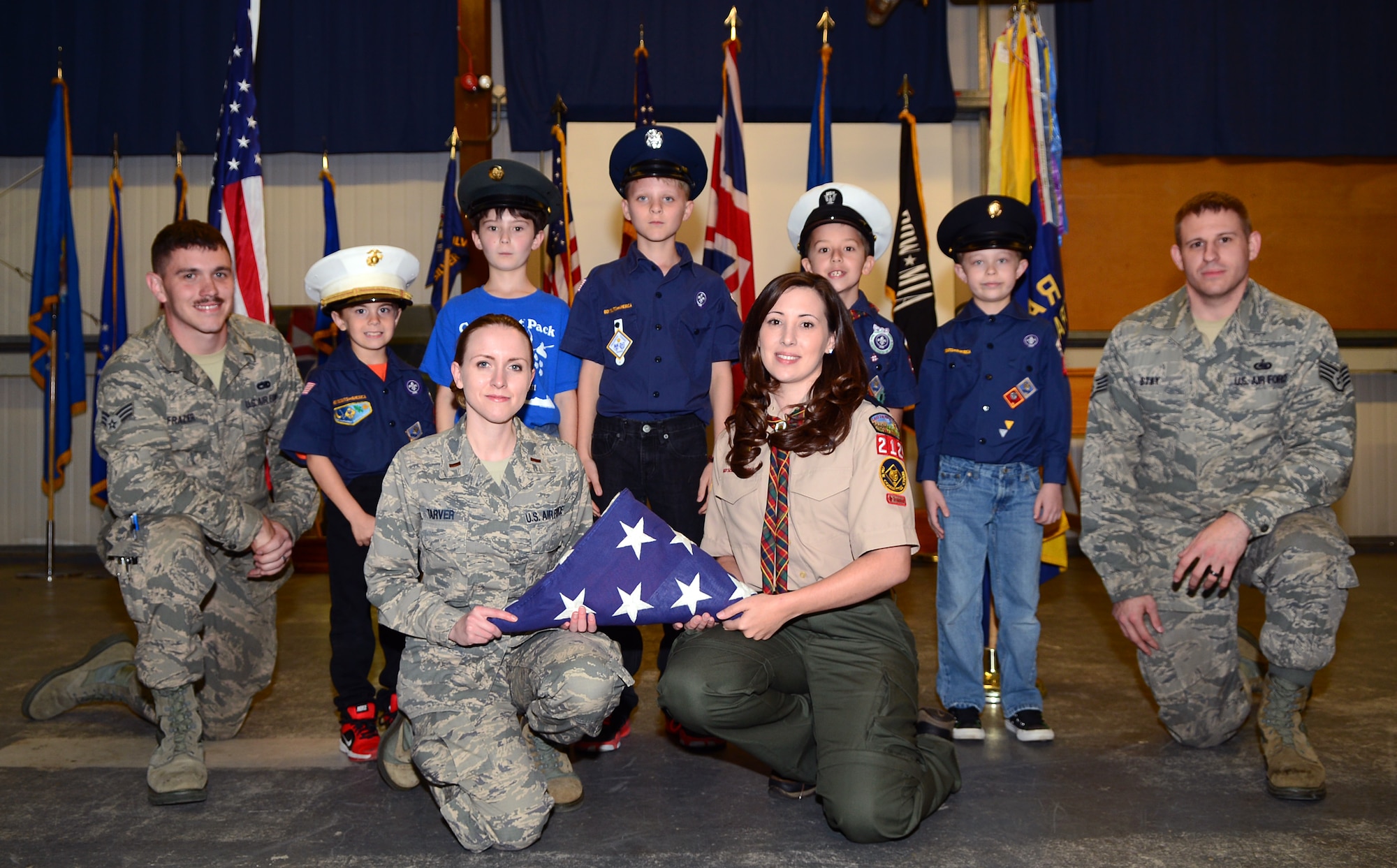 Team Mildenhall Honor Guard members and Cub Scout Pack 215 pose for a photo Oct. 8, 2014, on RAF Mildenhall, England. The honor guard taught Pack 215 how to perform different honor guard duties such as how to post colors and retire colors. (U.S. Air Force photo/Airman 1st Class Jonathan Light/Released)