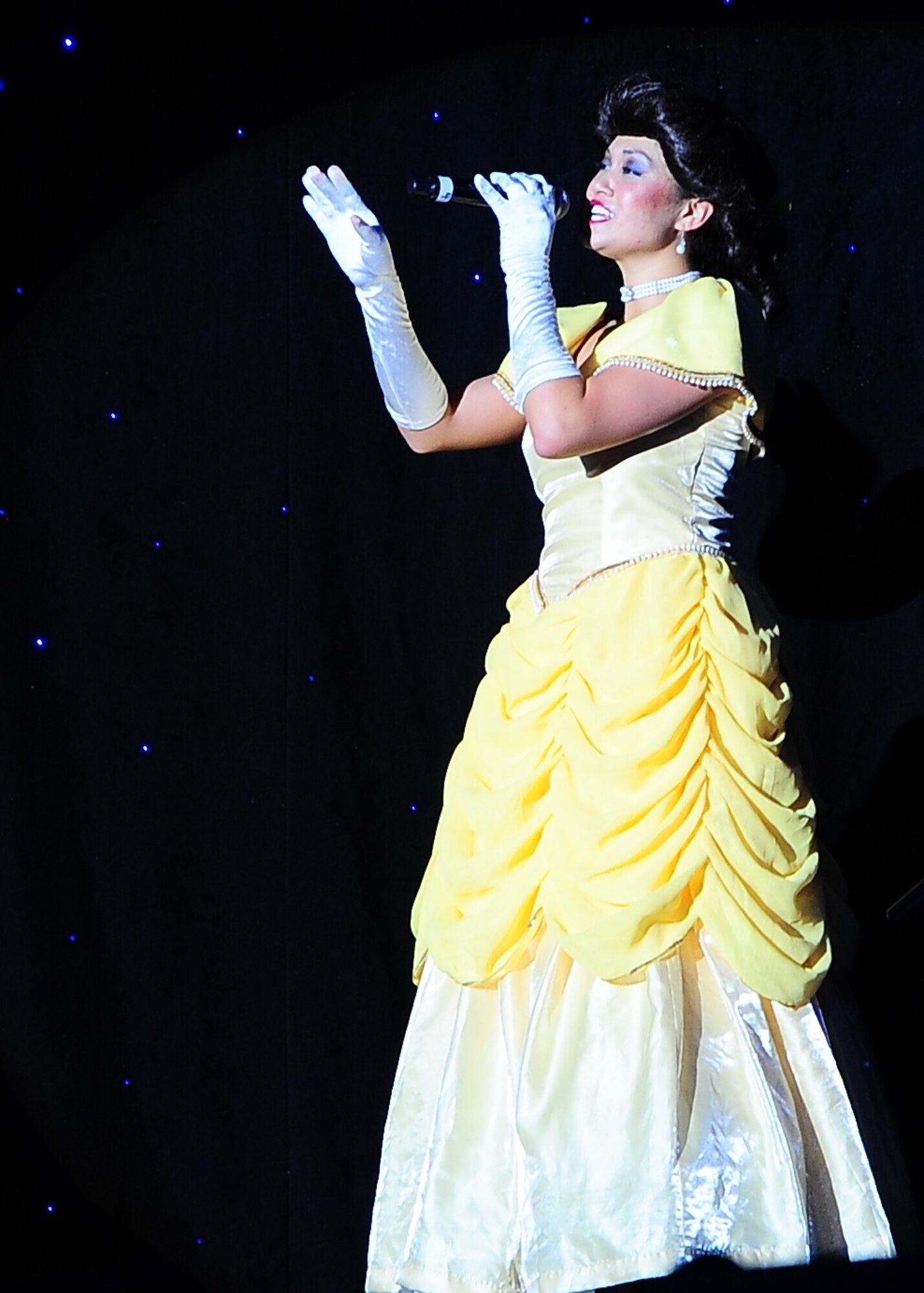 Staff Sgt. Gina Lavender, Tops In Blue vocalist, performs “Tale As Old As Time” as Belle from Beauty and the Beast during the Tops In Blue performance Oct. 14 at the Mississippi University for Women’s Whitfield Hall. Along with Belle, other popular movie characters graced the stage for the family-friendly show. (U.S. Air Force Photo/Airman John Day)
