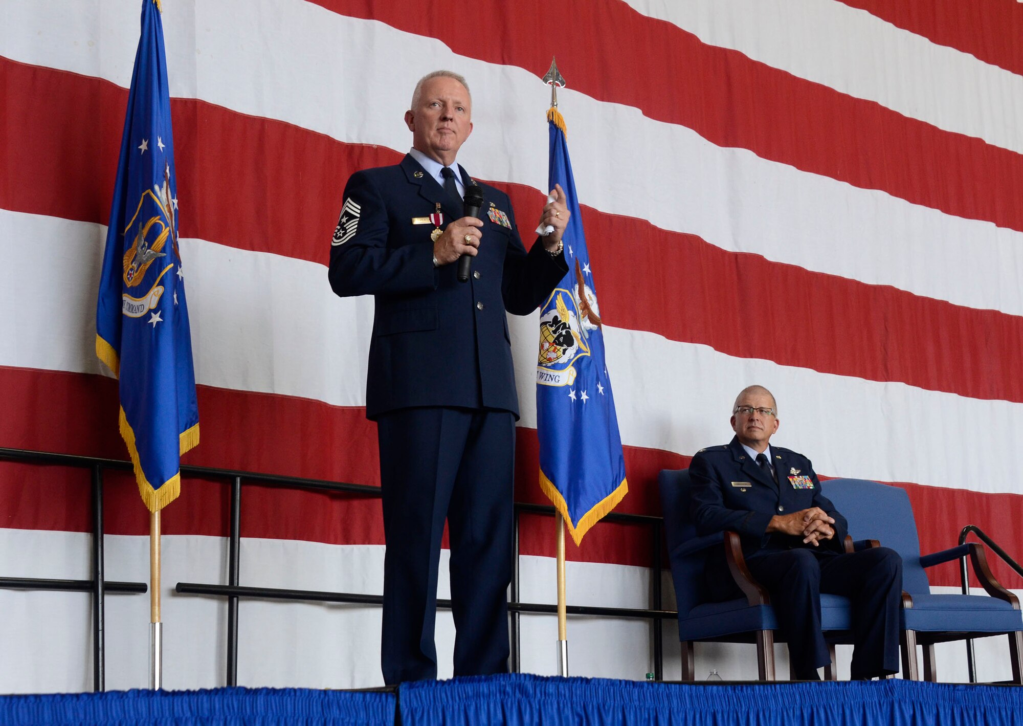 Chief Master Sgt. Wendell L. Peacock, 94th Airlift Wing command chief is honored by over 600 people for 33 years of military service during a retirement ceremony at Dobbins Air Reserve Base, Aug. 2, 2014. Col. (Ret) Timothy Tarchick looks on. “We’re here to celebrate a brave and honorable man’s career,” said Tarchick, who presided over the ceremony. “In February 2011, I hired a fantastic leader to maintain the readiness of our enlisted force - a man of character, integrity, and trustworthiness.” (U.S. Air Force photo/Don Peek)