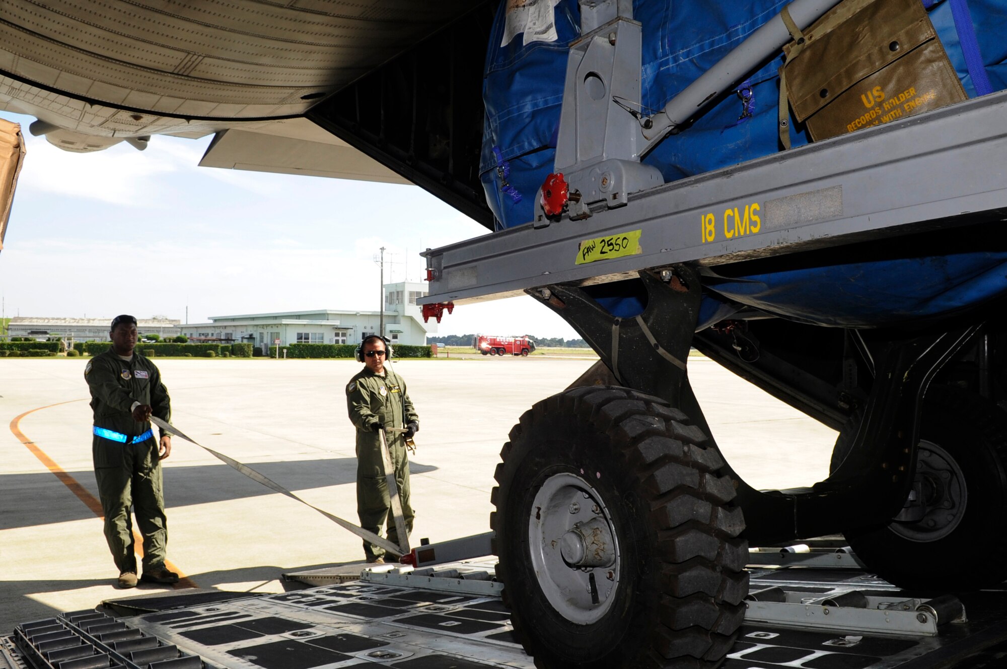 U.S. Air Force Staff Sgt. Christopher Shepheard, left, and Tech. Sgt. John Betran, both 374th Aircraft Maintenance Squadron crewchiefs, lower an F-15 Eagle engine out of a C-130 Hercules on Nyutabaru Air Base, Japan, Oct. 16, 2014. This was part of a two week-long Aviation Training Relocation Program designed to increase operational readiness between U.S. and Japanese forces. (U.S. Air Force photo by Senior Airman Marcus Morris/Released)