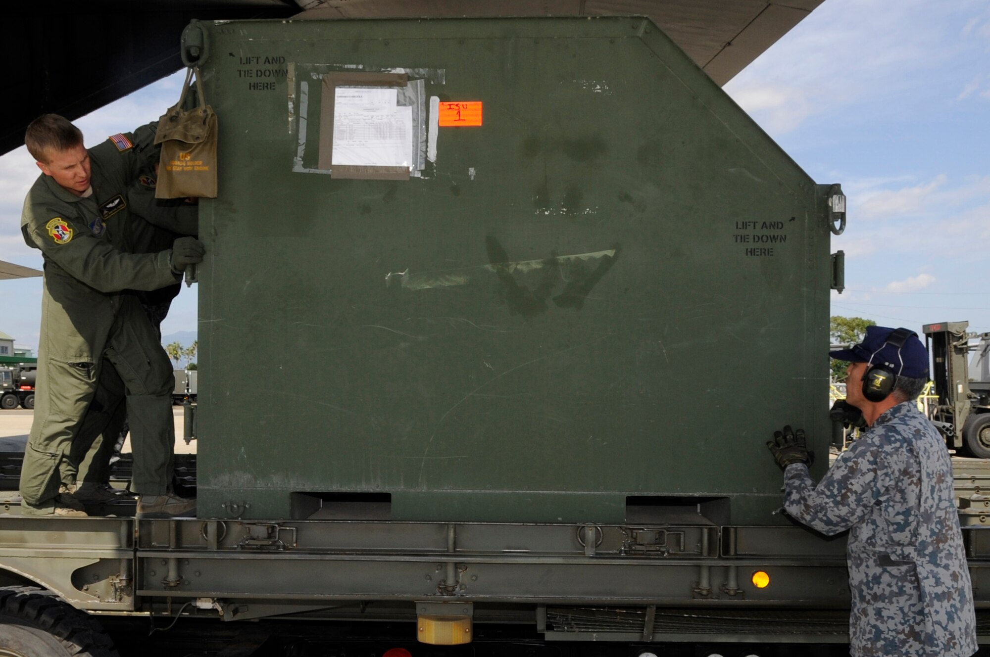 U.S. Air Force Staff Sgt. Renford Forbes, 36th Airlift Squadron loadmaster from Yokota Air Base, Japan, unloads supplies for an Aviation Training Relocation Program on Nyutabaru Air Base, Japan, Oct. 16, 2014. The ATR will be two weeks long and will give Kadena Airmen an opportunity to practice deployed operations and perform bi-lateral training while strengthening strategic partnerships with both their 5th Air Wing and 8th Air Wing Japan Air Self-Defense Force counterparts. (U.S. Air Force photo by Senior Airman Marcus Morris/Released)