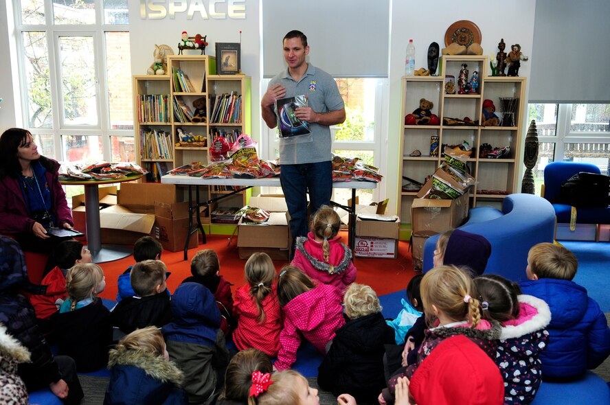 U.S. Air Force Tech. Sgt. Brent Watkins, 100th Civil Engineer Squadron Fire Department crew chief from Spring Hill, Fla., talks to children about what to do in the event of a fire Oct. 13, 2014, at St. Mary’s Church of England Academy in Mildenhall, England. RAF Mildenhall’s Fire Prevention Week is Oct. 12 to 17 and events included visits to local primary schools, reading to children at the base child development center and grease pan fire demonstrations. Additionally, the fire department is scheduled to host a fire muster and open house Oct. 17. (U.S. Air Force photo/Karen Abeyasekere/Released)