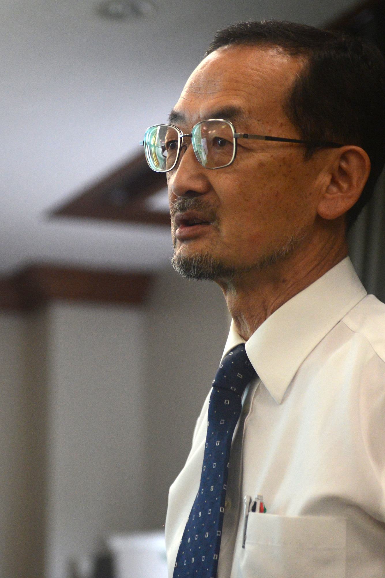 Yoshitaka Yamaguchi, 374th Civil Engineer Squadron cultural and natural resources program manager, briefs city officials on the environmental management system at Yokota Air Base, Japan, Oct. 10, 2014. The system details contingencies for storage and containment of hazardous materials and waste. (U.S. Air Force photo by Airman 1st Class David C. Danford/Released)