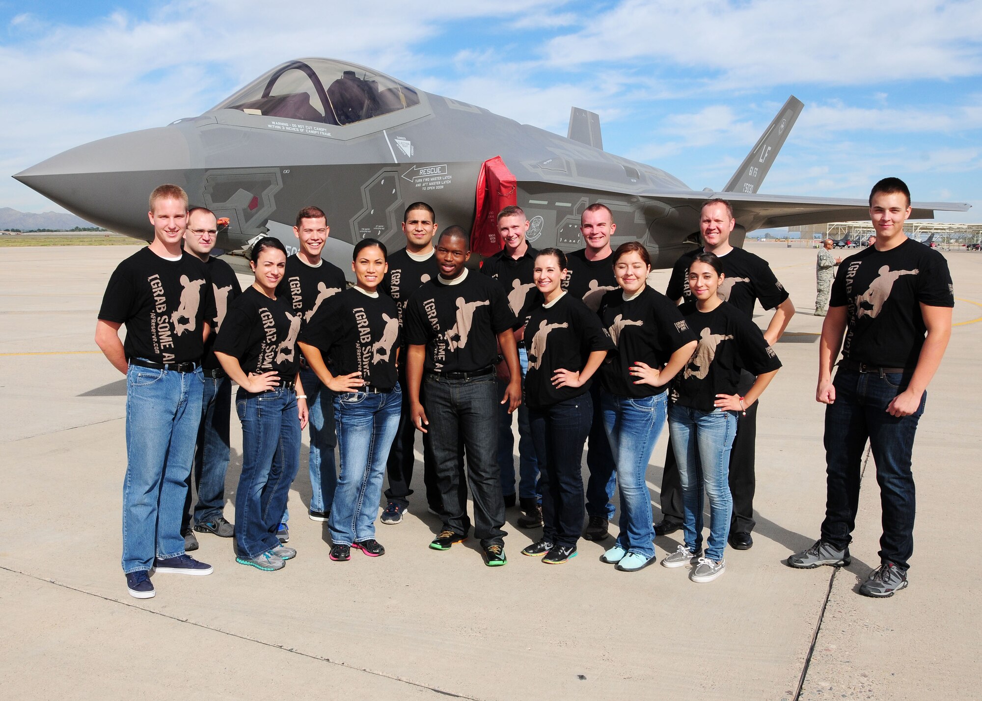 944th Fighter Wings newest enlistees pose in front of an F-35 after raising their hands taking a huge step into their future by enlisting into the U.S. Air Force Reserve during a “Total Force” mass enlistment held during the October UTA at Luke Air Force Base, Ariz.. (U.S. Air Force photo taken by Tech Sgt. Louis Vega Jr.)