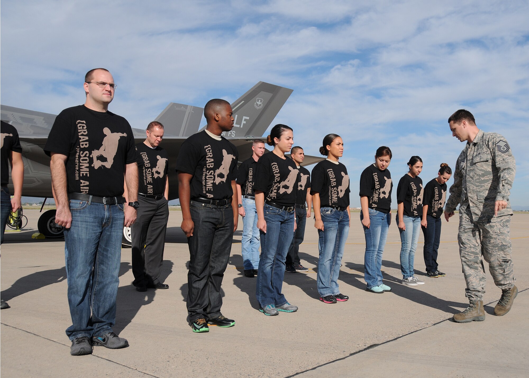 Master Sgt. Gabriel Klemm, 944th Fighter Wing delayed entry training facilitator, organizes 14 recruits before their enlistment into the U.S. Air Force Reserve at Luke Air Force Base, Ariz.. (U.S. Air Force photo taken by Staff Sgt. Joshua Nason)