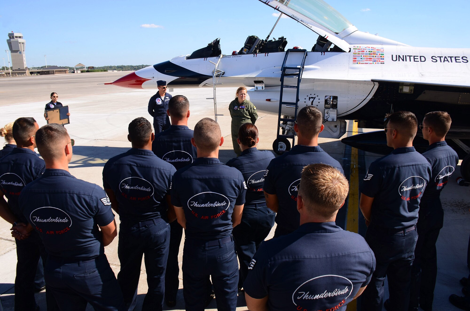 Mrs. Debra Murdock, principal of Cherokee High School in Canton, Georgia, thanks thunderbird team members for their help with her flight and service to America after her Hometown Hero orientation flight at Dobbins Air Reserve Base, Georgia, Oct., 17. The USAF Air Demonstration Squadron Thunderbirds are using Dobbins as their base of operations for their performances at the Wings Over North Georgia Air Show this weekend at the Russell Regional Airport in Rome, Georgia . (U.S. Air Force photo/ Brad Fallin)