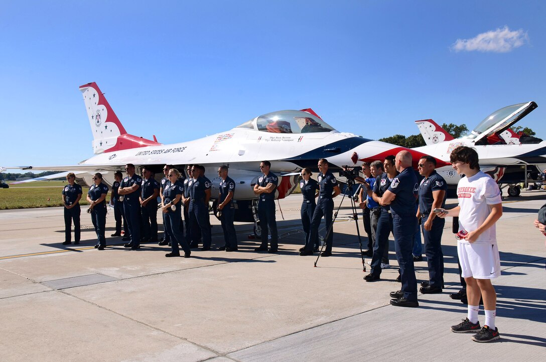Thunderbird team members assemble to give Mrs. Debra Murdock, principal of Cherokee High School in Canton, Georgia, a "hero's" welcome after her Hometown Hero orientation flight at Dobbins Air Reserve Base, Georgia, Oct., 17. The USAF Air Demonstration Squadron Thunderbirds are using Dobbins as their base of operations for their performances at the Wings Over North Georgia Air Show this weekend at the Russell Regional Airport in Rome, Georgia . (U.S. Air Force photo/ Brad Fallin)