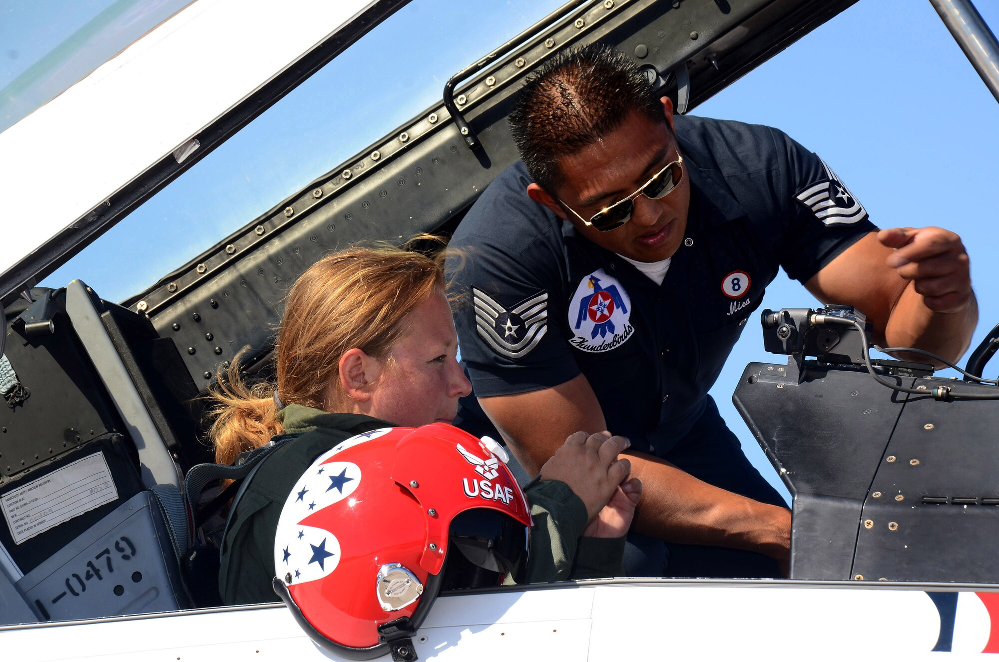 Tech. Sgt. Mark Mira, dedicated crew chief for Thunderbird #8, shows Mrs. Debra Murdock, principal for Cherokee High School in Canton, Georgia, some settings on the instrument panel prior to her Hometown Hero orientation flight at Dobbins Air Reserve Base, Georgia, Oct., 17. The USAF Air Demonstration Squadron Thunderbirds are using Dobbins as their base of operations for their performances at the Wings Over North Georgia Air Show this weekend at the Russell Regional Airport in Rome, Georgia . (U.S. Air Force photo/ Brad Fallin)
