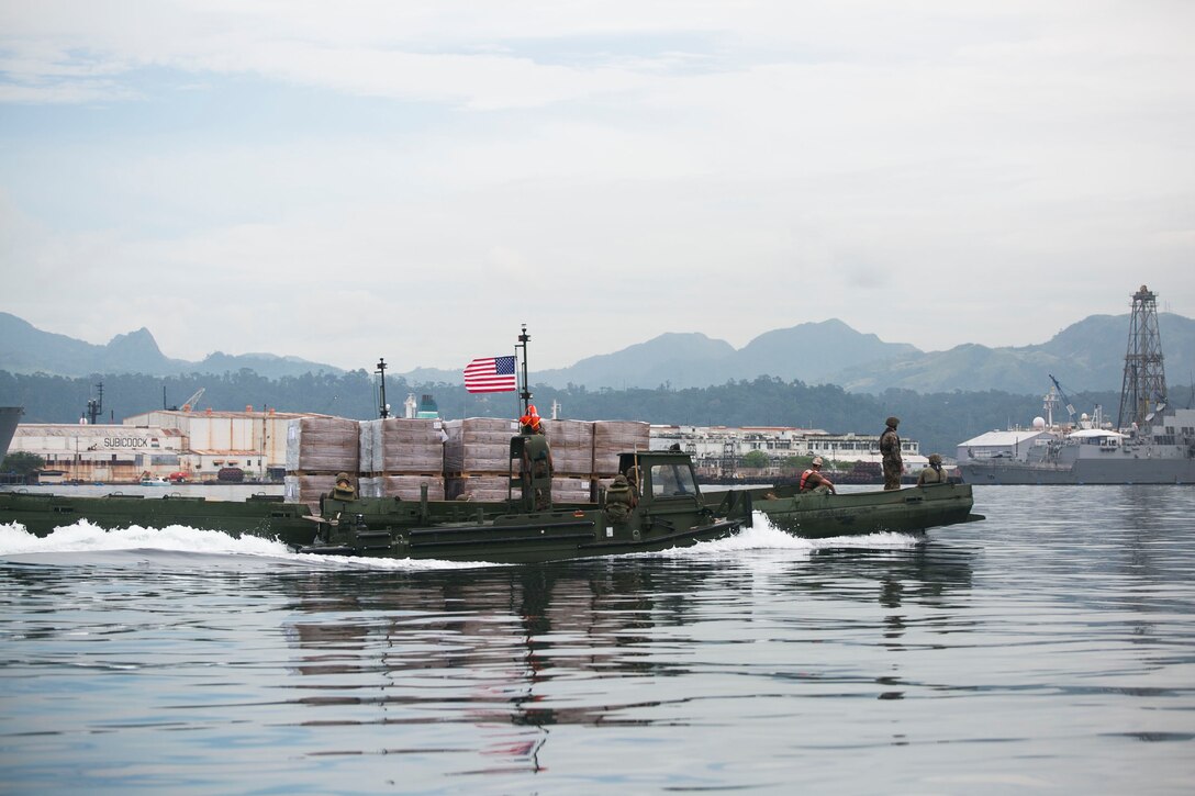 U.S. Marines participating in T-AKE 14-2 transport pallets of Meals, Ready-to-Eat using components of an Improved Ribbon Bridge pushed by Bridge Erection Boats while executing ship-to-shore transport operations Oct. 8 in logistical support of Amphibious Landing Exercise 2015 in Subic Bay, Philippines. The operations proved the concept that IRB components can be used in conjunction with BEBs on the open ocean as a ship-to-shore connector for transporting supplies and equipment to Marines on shore. The Marines are combat engineers with 9th Engineer Support Battalion, 3rd Marine Logistics Group, III Marine Expeditionary Force, currently assigned to Combat Logistics Detachment 379, Headquarters Regiment, 3rd MLG, III MEF. T-AKE 14-2 is a maritime pre-positioned force, multi-country theater security cooperation event that deployed from Okinawa aboard the USNS Sacagawea to participate in training exercises throughout the Asia-Pacific area of operations. 