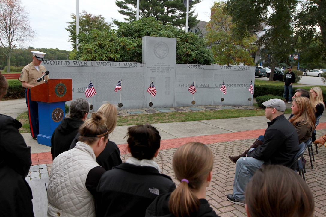First Sgt. Shane Dillon addresses the friends and family of Sgt. Daniel Vasselian before posthumously awarding him the Bronze Star Medal with Combat Distinguishing Device Oct. 13, in front of the American Legion’s Lewis V. Dorsey Post 112 War Memorial in Abington, Mass. Karen’s son, Sgt. Daniel Vasselian was posthumously awarded the Bronze Star Medal with Combat Distinguishing Device for combat actions while on his third deployment to Afghanistan. Daniel’s wife, Erin Vasselian, and parents, Karen and Mark Vasselian, each were presented with medals during the ceremony. Daniel was killed in action Dec. 23, 2013 in Helmand Province, Afghanistan. 