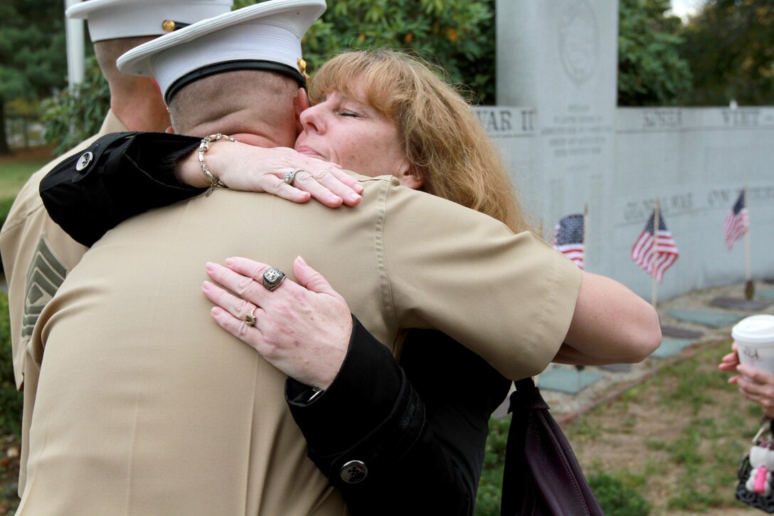 Karen Vasselian embraces Maj. James Nolan, Inspector-Instructor for Headquarters and Service Company and Weapons Company, , 1st Battalion, 25th Marine Regiment, following a ceremony where her son, Sgt. Daniel Vasselian, was posthumously awarded the Bronze Star Medal with Combat Distinguishing Device, Oct. 13, in front of the American Legion’s Lewis V. Dorsey Post 112 War Memorial in Abington, Mass. Daniel was posthumously awarded the Bronze Star Medal with Combat Distinguishing Device for combat actions while on his third deployment to Afghanistan. Daniel’s wife, Erin Vasselian, and parents, Karen and Mark Vasselian, each were presented with medals during the ceremony. Daniel was killed in action Dec. 23, 2013 in Helmand Province, Afghanistan. 