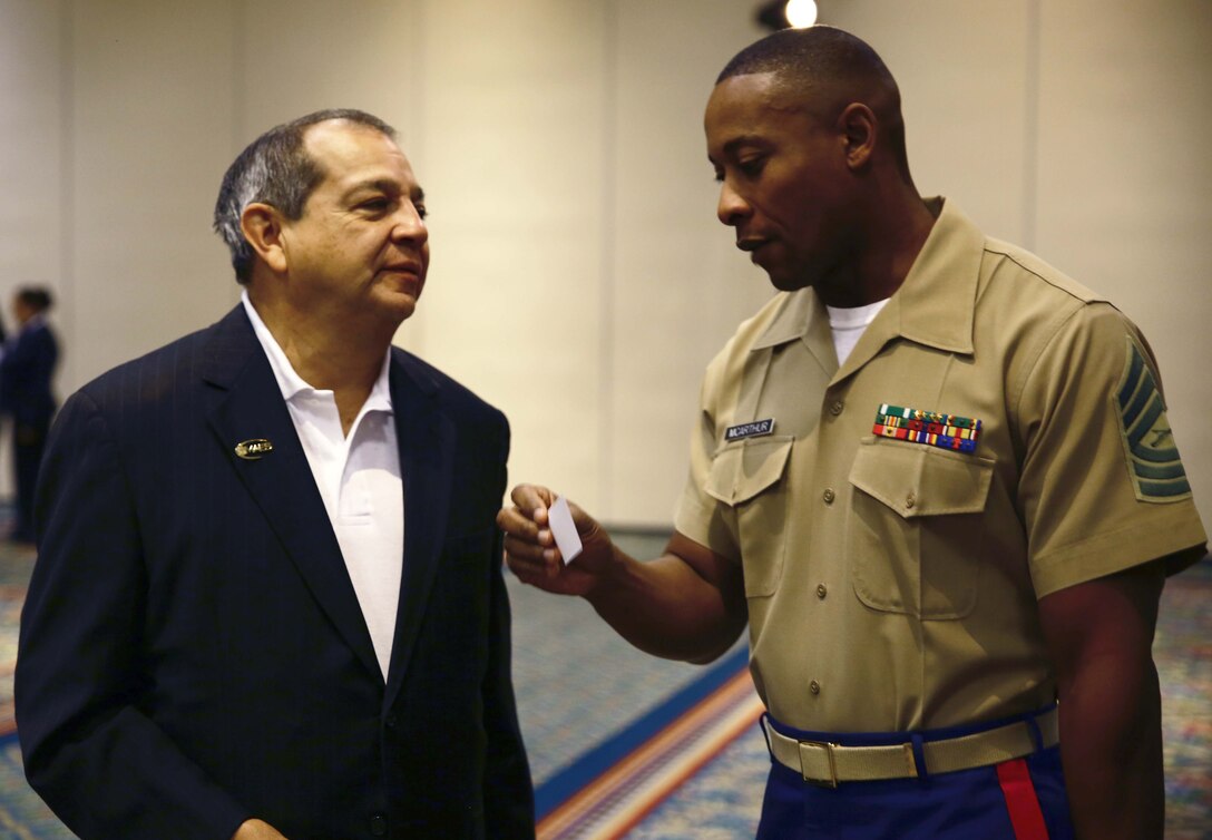 Mike Acosta, Associate Vice President of Strategy and Partnerships, MAES, and Master Sgt. Mark McArthur, Diversity Chief, Marine Corps Recruiting Command, discuss the importance of the partnership between the Marine Corps and MAES during the Industry Advisory Council meeting and partners breakfast, here, today. The mission of MAES is to promote, cultivate, and honor excellence in education among engineers and scientist of Latin American descent.