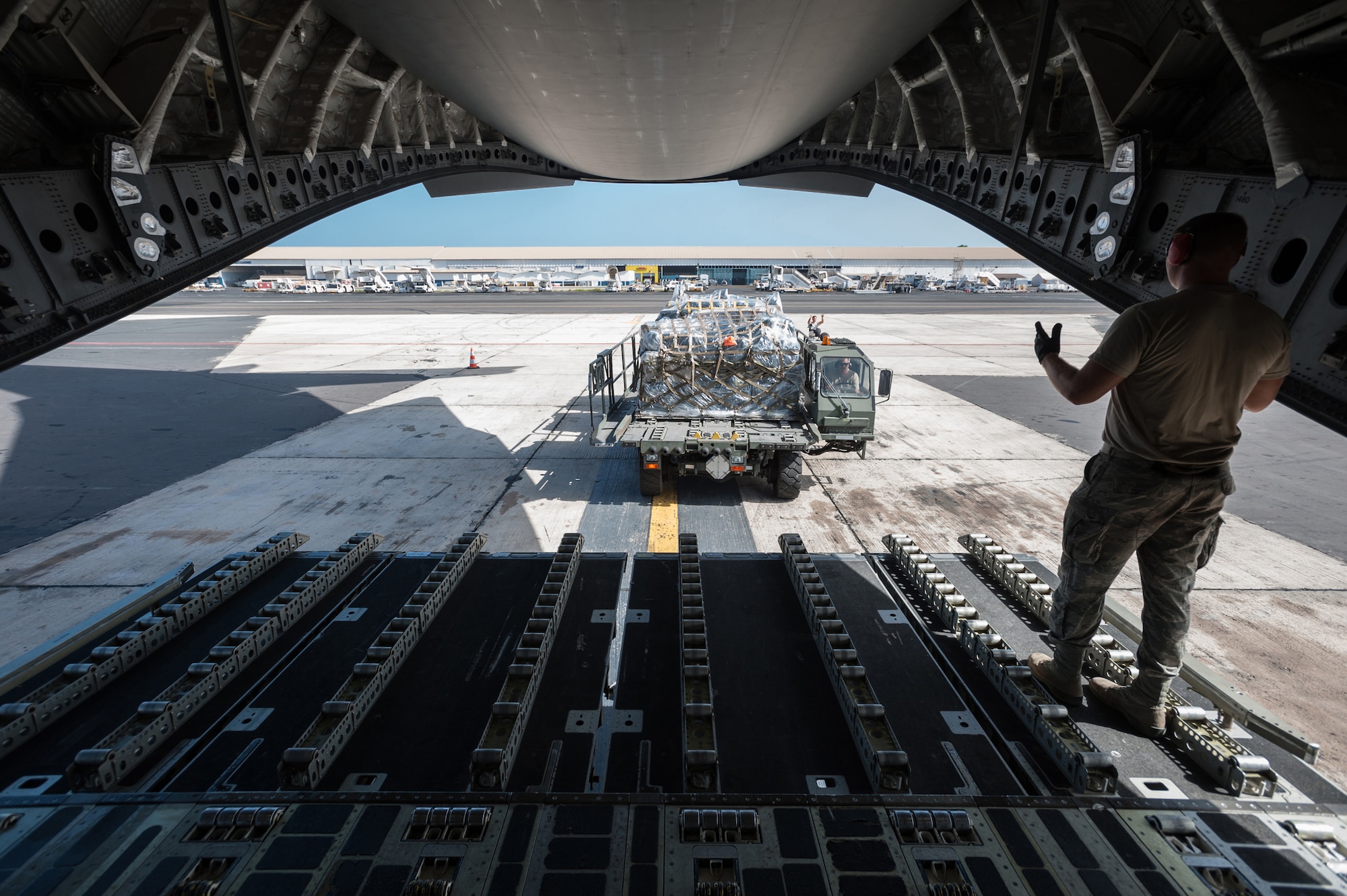 Airmen from the Kentucky Air National Guard’s 123rd Contingency Response Group offload cargo pallets from a C-17 Globemaster III, Oct. 18, 2014, as part of ramp operations at Léopold Sédar Senghor International Airport in Dakar, Senegal, in support of Operation United Assistance. The Airmen are operating an intermediate staging base in Dakar to funnel humanitarian aid and military support cargo into affected areas, working in concert with Soldiers from the U.S. Army’s 689th Rapid Port Opening Element to staff a Joint Task Force-Port Opening as part of the U.S. Agency for International Development-led, whole-of-government effort to respond to the Ebola outbreak. The C-17 is assigned to Travis Air Force Base, Calif. (U.S. Air National Guard photo/Maj. Dale Greer)