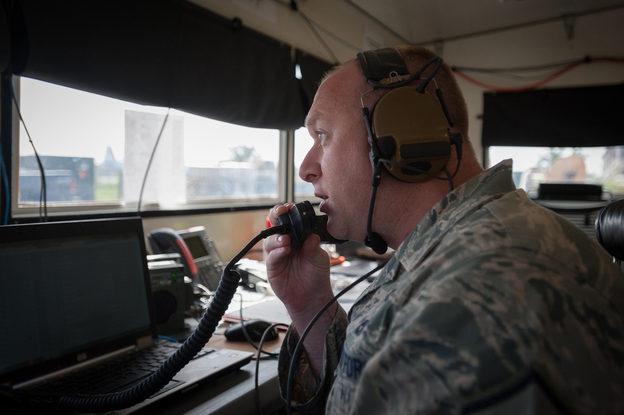 Master Sgt. Michael Skeens coordinates air movement from a mobile airfield operations center Oct. 18, 2014, at Léopold Sédar Senghor International Airport in Dakar, Senegal. Skeens and more than 70 other Airmen from the Kentucky Air National Guard’s 123rd Contingency Response Group are operating a cargo hub in Senegal to funnel humanitarian supplies and military support equipment into West Africa as part of Operation United Assistance, the U.S. Agency for International Development-led, whole-of-government effort to respond to the Ebola outbreak. Skeens is a command post controller for Joint Task Force-Port Opening Senegal. (U.S. Air National Guard photo/Maj. Dale Greer)