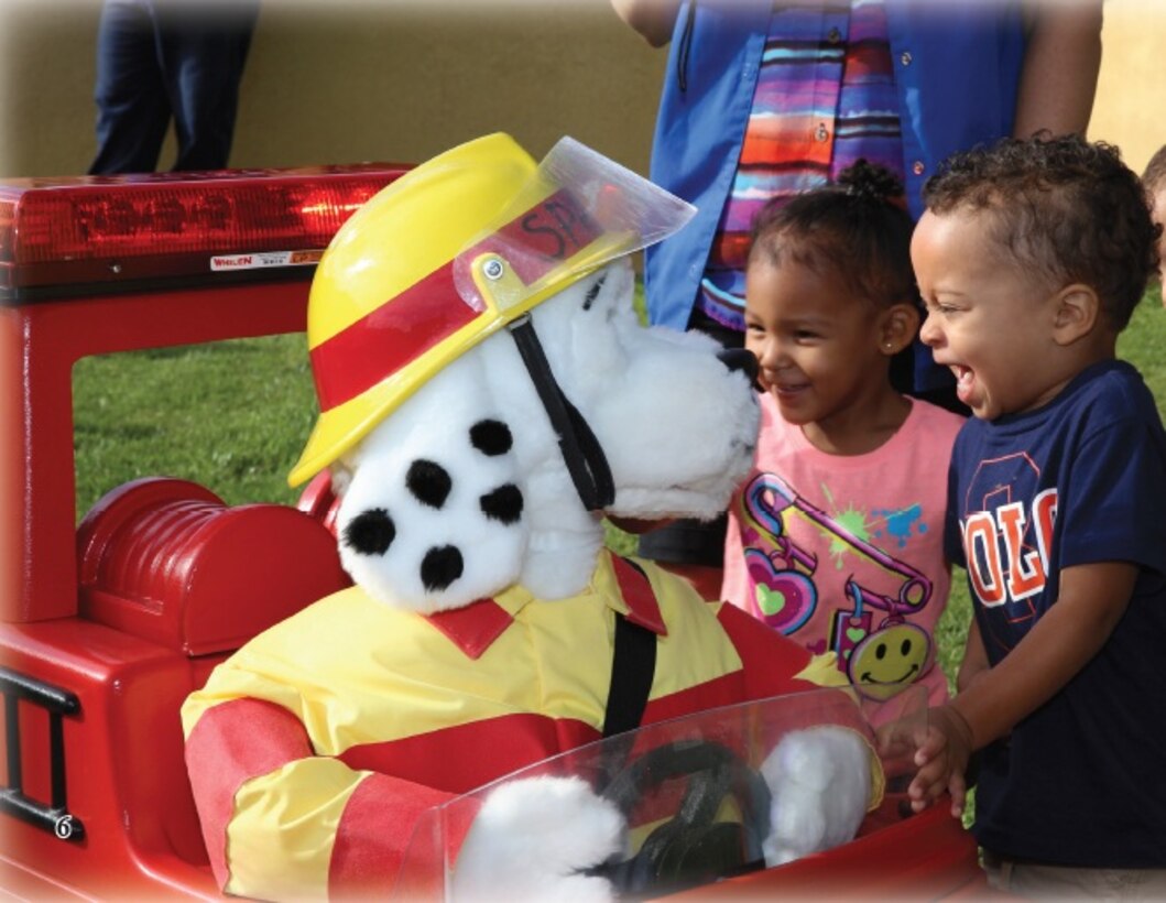 The Marine Corps Logistics Base Barstow Fire Department visits with children from the Child Development Center here, Oct. 7, in support of Fire Prevention Week 2014. Marvin Torgeson, a firefighter here, acted as Sparky the Firedog as he interacted with children and taught them about the importance of fire safety.