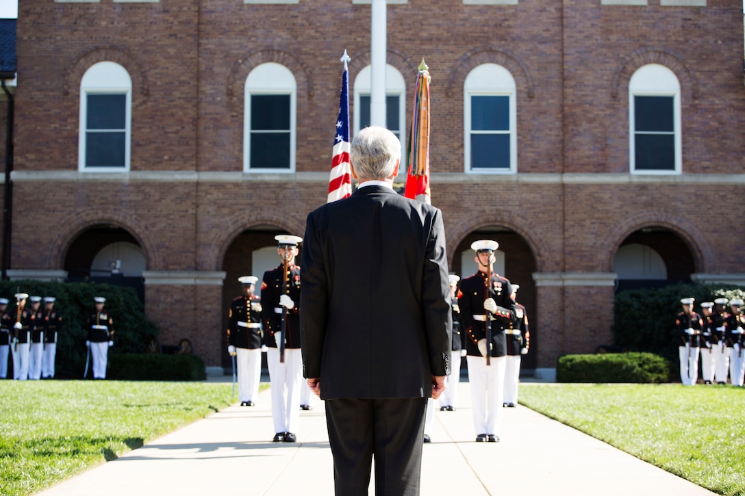 The Secretary of Defense Chuck Hagel stands at attention before giving his remarks on Gen. James Amos during the commandant passage of command ceremony at Marine Barracks Washington, D.C., Oct. 17. After 44 years of honorable service to the Corps, Gen. James Amos passed the torch to Gen. Joseph Dunford. (U.S. Marine Corps photo by Cpl. Clayton Filipowicz/Released)