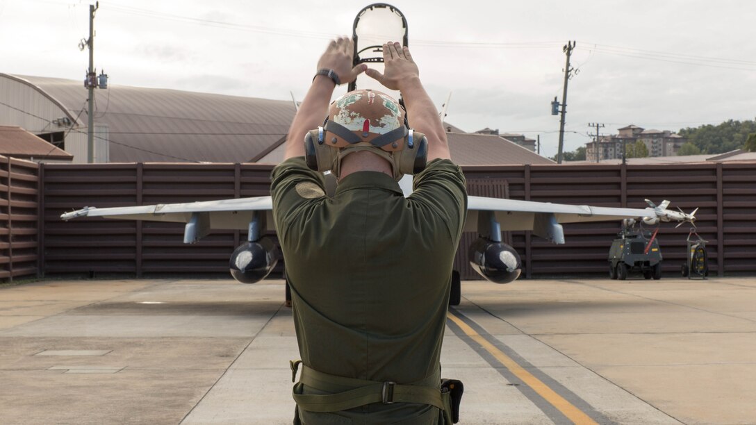 Lance Cpl. Justin Murray, a powerline mechanic with Marine All-Weather Fighter Attack Squadron 533, performs pre-flight checks on an F/A-18 Hornet during the Korean Marine Exchange Program 14-13, Oct. 13, 2014, on Osan Air Base, Republic of Korea. KMEP 14-13 is a multinational exercise that focuses on the integration of aviation and ground assets within the construct of a traditional Combined Arms Live Fire Exercise. Supporting units include, but are not limited to, Marine Aviation Logistics Squadron 12 and Marine Wing Support Squadron 171.