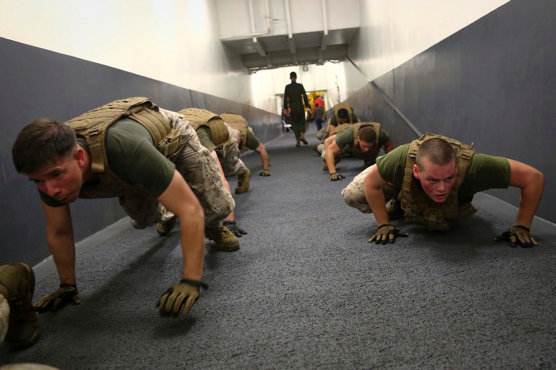 11th Marine Expeditionary Unit (MEU) Marines assigned to Combat Cargo, USS Makin Island (LHD 8), perform the spiderman up a ramp as part of a conditioning program for the Marine Corps Martial Arts Program, Oct. 16. The Makin Island Amphibious Ready Group (ARG) and the embarked 11th MEU are deployed in support of maritime security operations and theater security cooperation efforts in the U.S. 5th Fleet area of responsibility. (U.S. Marine Corps photo by Cpl. Laura Y. Raga/Released)
