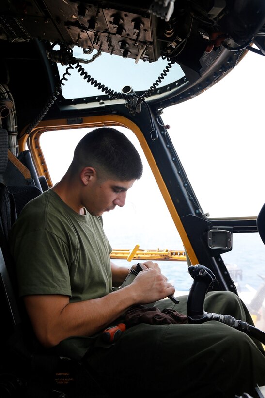 U.S. Marine Corps Sgt. Brandon J. Arroyo, an avionics collateral duty inspector with Marine Medium Tiltrotor Squadron 163 (Reinforced), 11th Marine Expeditionary Unit (MEU), and native of Westminster, California, cleans a component of a CH-53E Super Stallion cockpit as part of scheduled preventive maintenance on the flight deck of the amphibious transport dock ship            USS San Diego (LPD 22), Oct. 17. Marines with the 11th MEU are deployed with the San Diego and with the Makin Island Amphibious Ready Group as a theater reserve and crisis response force throughout U.S. Central Command and the U.S. 5th Fleet area of responsibility. (U.S. Marine Corps photos by Gunnery Sgt. Rome M. Lazarus/Released)  