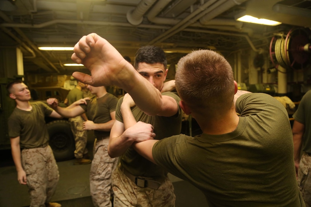 Marines with Golf Company, Battalion Landing Team 2nd Battalion, 1st Marines, 11th Marine Expeditionary Unit (MEU), conduct MCMAP training aboard the USS Makin Island (LHD 8), Oct. 14. The Makin Island Amphibious Ready Group (ARG) and embarked 11th MEU provide a versatile sea-based, expeditionary force that can be tailored to a variety of missions in the U.S. 5th Fleet area of responsibility. (U.S. Marine Corps photos by Cpl. Demetrius Morgan/ Released)
