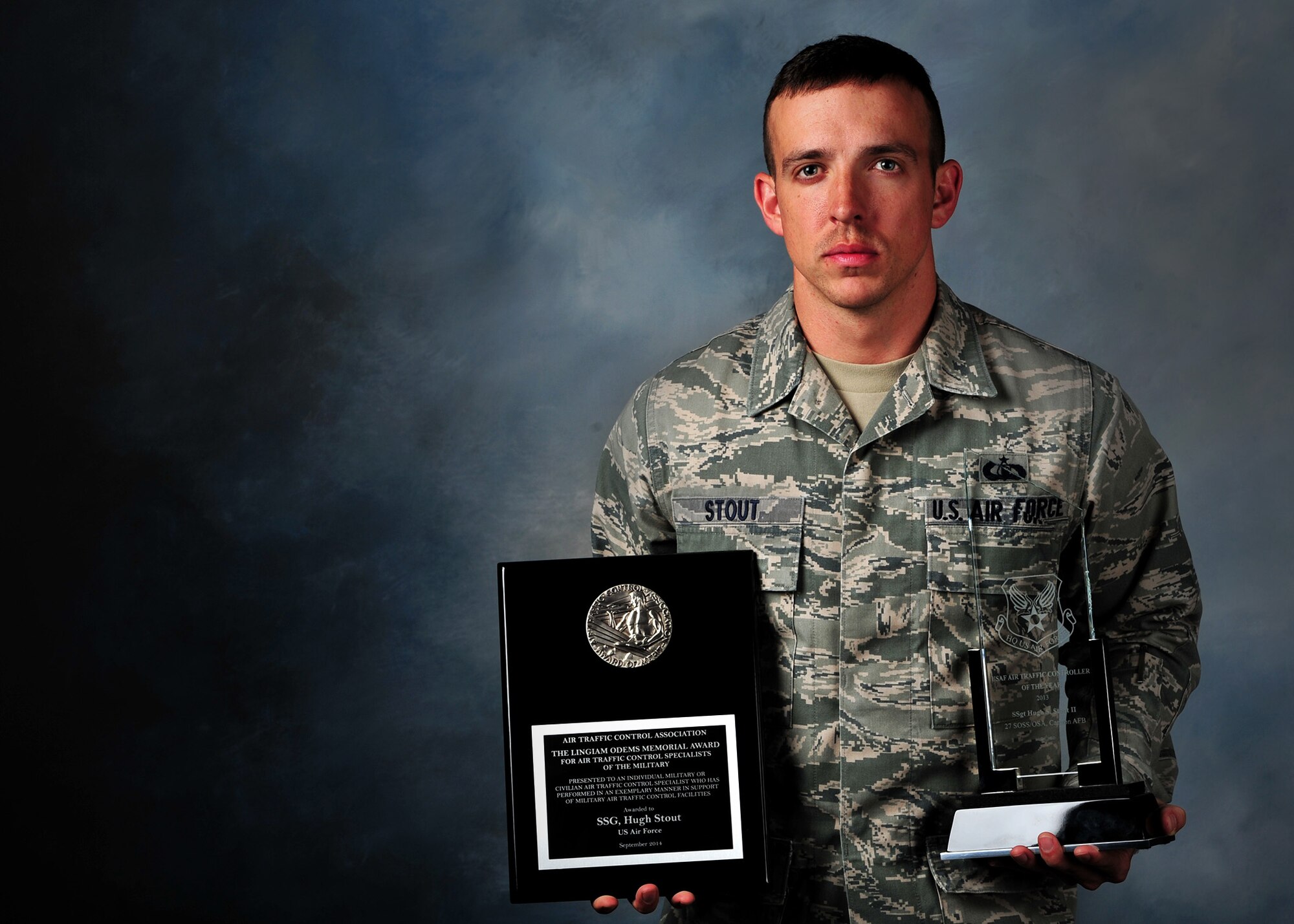 U.S. Air Force Staff Sgt. Hugh “Scotty” Stout II, 27th Special Operations Support Squadron air traffic controller, holds up recently received awards Oct. 14, 2014 at Cannon Air Force Base, N.M. Stout was awarded for performing in an exemplary manner in support of military ATC facilities. (U.S. Air Force photo/Airman 1st Class Chip Slack) 
